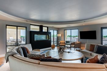 a living room filled with furniture and a flat screen tv  at Century West Pryor, Lee's Summit, 64081